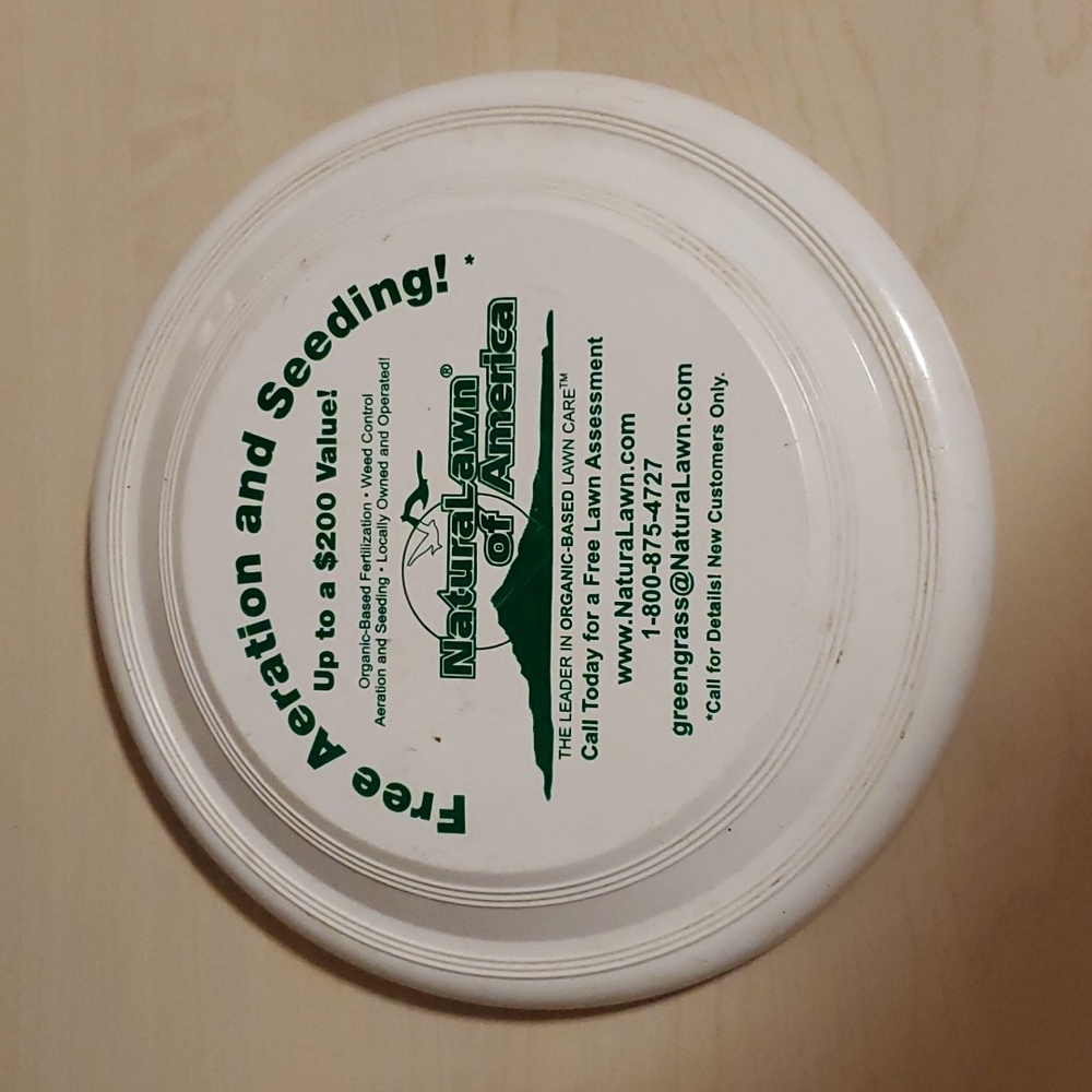 White Frisbee advertising Free Aeration and Seeding